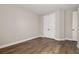 Spacious bedroom with wood-look flooring, neutral paint, and a large closet at 7878 Greengard St, Orlando, FL 32827