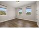 Bedroom with hardwood floors and dual windows providing natural light and neighborhood views at 7878 Greengard St, Orlando, FL 32827
