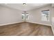 Spacious bedroom featuring hardwood floors, recessed lighting, and multiple windows for natural light at 7878 Greengard St, Orlando, FL 32827