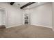 Bedroom featuring carpet floors, a large window, and wooden ceiling beams at 7878 Greengard St, Orlando, FL 32827