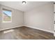 Bedroom showcasing wood-look floors and a window bringing in natural light at 7878 Greengard St, Orlando, FL 32827