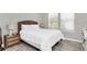 Cozy bedroom with a comfortable bed, wicker headboard, and light-filled windows for a relaxing atmosphere at 7878 Greengard St, Orlando, FL 32827