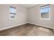 Cozy bedroom with wood-look floors and two windows providing lots of natural light at 7878 Greengard St, Orlando, FL 32827
