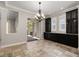 Dining room with black cabinets, tile flooring, and a view of the outdoor patio at 7878 Greengard St, Orlando, FL 32827