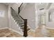 Elegant foyer showcasing staircase, tile flooring, and a welcoming entryway with a decorative front door at 7878 Greengard St, Orlando, FL 32827