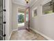 Foyer with tile flooring, decorative front door, and a view of the front yard at 7878 Greengard St, Orlando, FL 32827