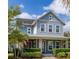 Inviting two-story house featuring a covered porch with stone pillars and beautiful landscaping at 7878 Greengard St, Orlando, FL 32827