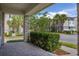 View from the covered front porch showcasing the paver flooring, stone columns, and neighborhood streetscape at 7878 Greengard St, Orlando, FL 32827