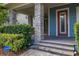 Covered front porch with stone pillars, brick pavers, and a decorative front door for added curb appeal at 7878 Greengard St, Orlando, FL 32827
