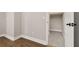 Hallway with hardwood floors transitioning to carpet, offering seamless flow to other rooms at 7878 Greengard St, Orlando, FL 32827