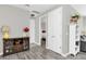 Hallway with stylish wood floors and neutral grey walls, connecting various rooms with white trim and door frames at 7878 Greengard St, Orlando, FL 32827