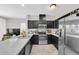 Modern kitchen with stainless steel appliances, dark cabinetry, and sleek countertops at 7878 Greengard St, Orlando, FL 32827