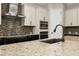 Close-up of kitchen with stainless steel appliances, modern fixtures, and an undermount sink at 7878 Greengard St, Orlando, FL 32827