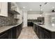Contemporary kitchen with stainless steel appliances, granite counters, and a stylish backsplash at 7878 Greengard St, Orlando, FL 32827