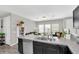 Open kitchen area with stainless steel dishwasher and a view of the living space at 7878 Greengard St, Orlando, FL 32827