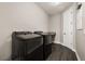 Laundry room features a dark washer and dryer with tile flooring at 7878 Greengard St, Orlando, FL 32827
