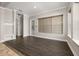 Bright living room with tile floors, neutral paint, an entry bench, and large window at 7878 Greengard St, Orlando, FL 32827