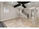 Open living room with tiled floors and a staircase with dark banisters at 7878 Greengard St, Orlando, FL 32827
