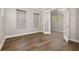 Spacious office with wood floors, neutral walls, and double glass doors at 7878 Greengard St, Orlando, FL 32827