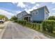 Charming blue two-story home with manicured landscaping and a black metal fence at 7878 Greengard St, Orlando, FL 32827