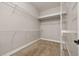 Bright walk-in closet featuring carpet and wire shelving for ample storage and organization at 7878 Greengard St, Orlando, FL 32827
