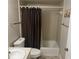 Neutral bathroom with a tub/shower combo and dark brown shower curtain at 8 Buck Cir # 8, Haines City, FL 33844
