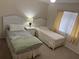 Bright bedroom featuring two twin beds, a lamp, and a window with curtains at 8 Buck Cir # 8, Haines City, FL 33844