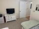 Carpeted bedroom featuring a TV, dresser, and a doorway leading to another room at 8 Buck Cir # 8, Haines City, FL 33844