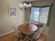 Cozy dining area with a wooden table, comfortable seating, and natural light from the window at 8 Buck Cir # 8, Haines City, FL 33844