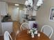Open kitchen featuring white cabinetry, modern appliances, with an adjacent dining area at 8 Buck Cir # 8, Haines City, FL 33844