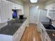 Bright kitchen features white cabinets, updated appliances, and sleek countertops providing ample workspace at 8 Buck Cir # 8, Haines City, FL 33844