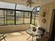Bright and airy sunroom with tile flooring, comfortable seating, and lovely views of the surrounding landscape at 8 Buck Cir # 8, Haines City, FL 33844