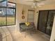 Serene sunroom with neutral decor, tile flooring, and comfortable seating perfect for relaxing and enjoying the view at 8 Buck Cir # 8, Haines City, FL 33844