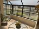 Bright sunroom with tile floors, comfortable seating, and views of the surrounding greenery at 8 Buck Cir # 8, Haines City, FL 33844