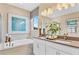 Modern bathroom featuring double sinks, a soaking tub, and stylish decor at 808 Wekiva Ridge Dr, Mount Dora, FL 32757