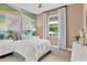 Comfortable bedroom with bright accent wall, white bedding, and natural light at 808 Wekiva Ridge Dr, Mount Dora, FL 32757