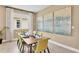 Inviting dining room with a modern table set for six next to a sunlit window at 808 Wekiva Ridge Dr, Mount Dora, FL 32757