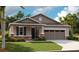 Charming single-Gathering home featuring stone accents, neutral siding, and a two-car garage at 808 Wekiva Ridge Dr, Mount Dora, FL 32757