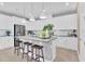 Bright, open kitchen featuring white cabinets, stainless steel appliances, and center island with barstool seating at 808 Wekiva Ridge Dr, Mount Dora, FL 32757