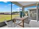 Screened patio featuring modern table and chairs overlooking backyard at 808 Wekiva Ridge Dr, Mount Dora, FL 32757