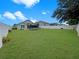 Well maintained backyard featuring lush grass, a trampoline, and a white privacy fence at 8439 Adele Rd, Lakeland, FL 33810