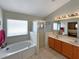 Bathroom featuring a bathtub, glass-enclosed shower, double vanity with mirror and natural light at 8439 Adele Rd, Lakeland, FL 33810