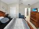 Bedroom with neutral walls, tile flooring, ceiling fan, and a large wooden bed at 8439 Adele Rd, Lakeland, FL 33810