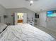 Primary bedroom featuring neutral tones, tile flooring, and a vanity with an en-suite bathroom at 8439 Adele Rd, Lakeland, FL 33810
