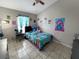 Charming bedroom with playful decor, a comfortable bed, and a ceiling fan at 8439 Adele Rd, Lakeland, FL 33810