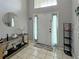 Bright entryway with tile flooring, a modern console table with decor, and a decorative mirror at 8439 Adele Rd, Lakeland, FL 33810