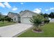 Attractive house with a well-kept lawn, driveway, and landscaping adds to its curb appeal at 8439 Adele Rd, Lakeland, FL 33810
