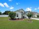 Well-maintained lawn surrounds this beautiful house with mature landscaping, including trees and shrubbery at 8439 Adele Rd, Lakeland, FL 33810