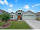 Charming single-Gathering home with well-manicured lawn, lush landscaping, and an attached two-car garage at 8439 Adele Rd, Lakeland, FL 33810