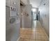 Hallway with gray walls, tiled flooring and white doors and trim at 8439 Adele Rd, Lakeland, FL 33810